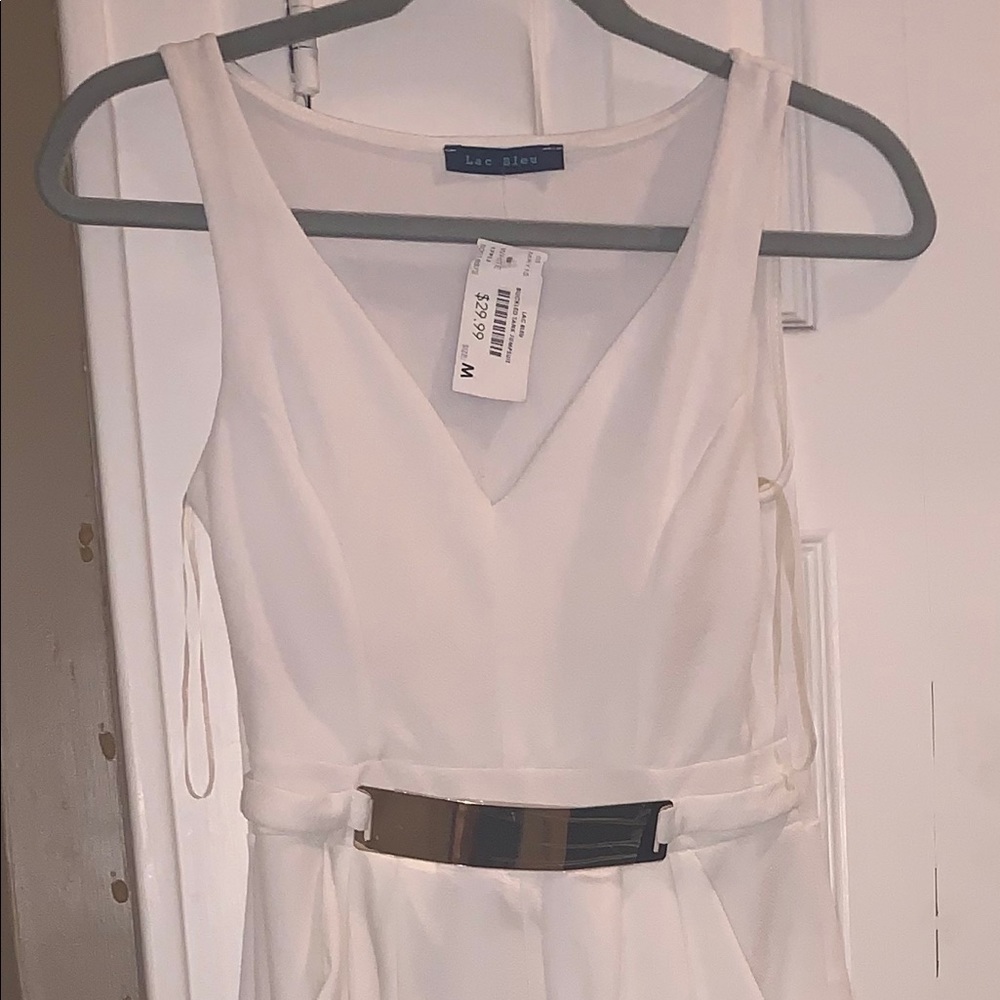 A brand new white jumpsuit that is ankle length.
